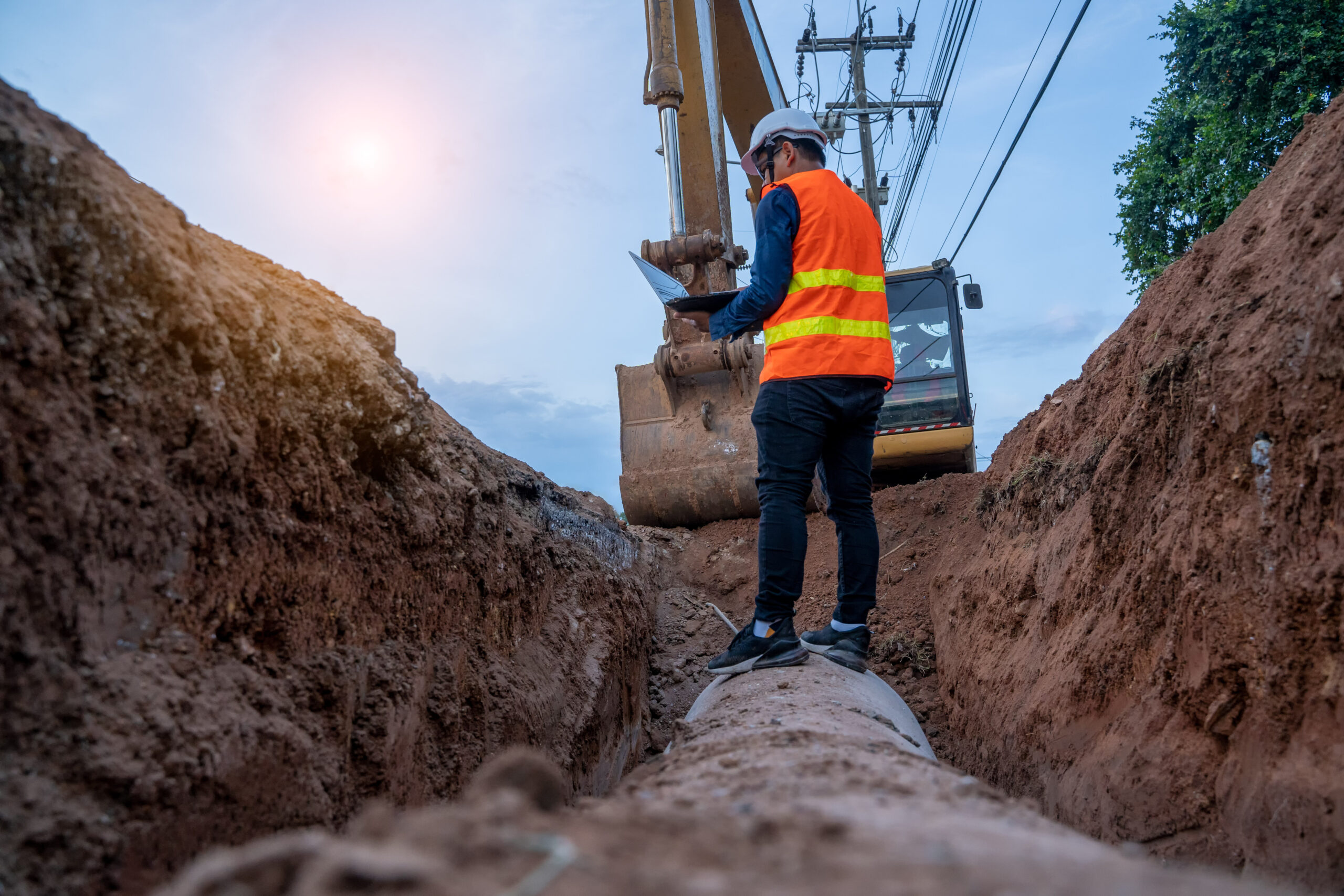 Engineer wear safety uniform examining excavation concrete Drain