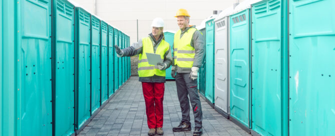 Workers checking the portable toilets for rental